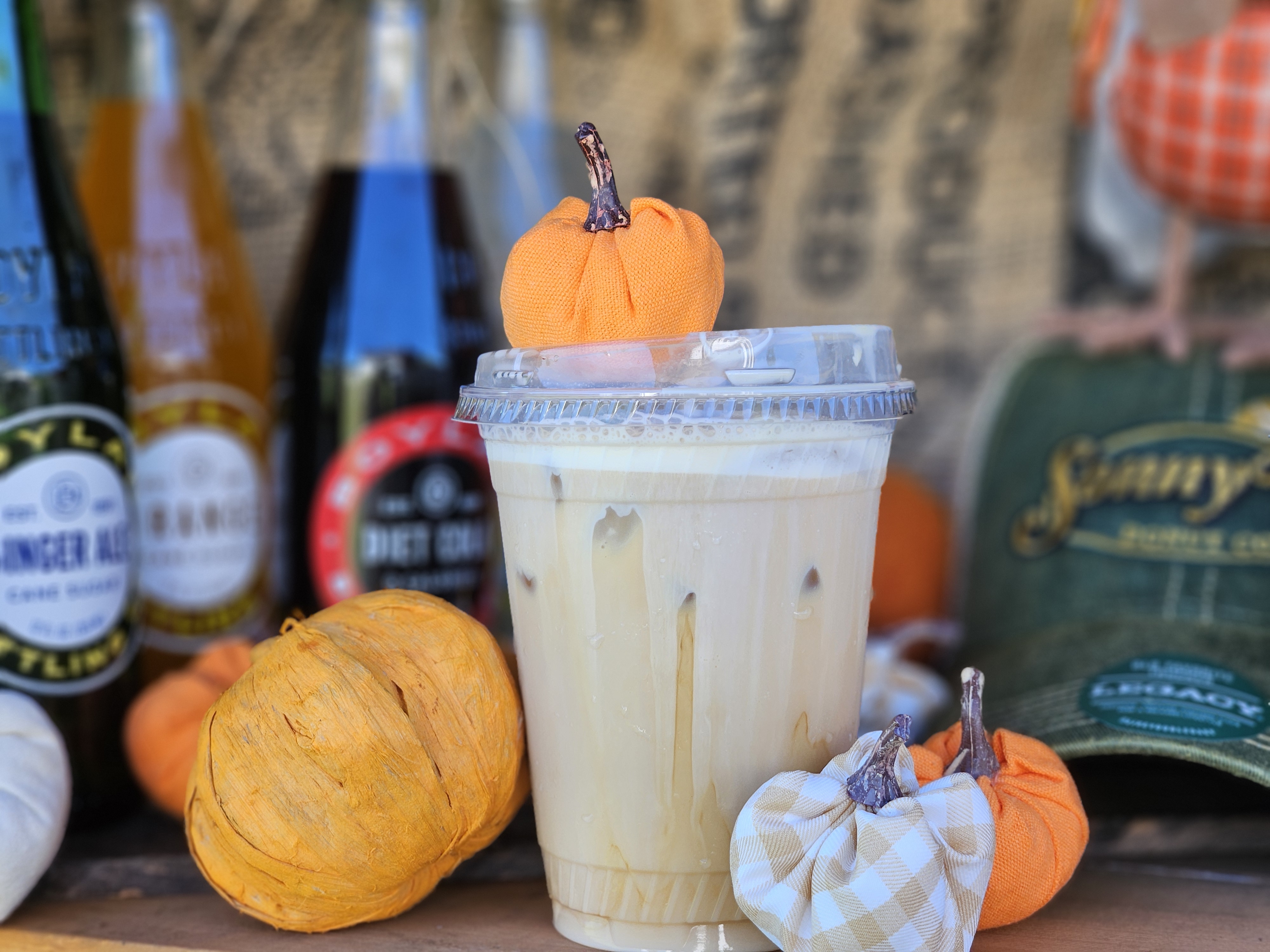 Signature iced coffee with seasonal harvest decor at Sonny Boy Donut Co.